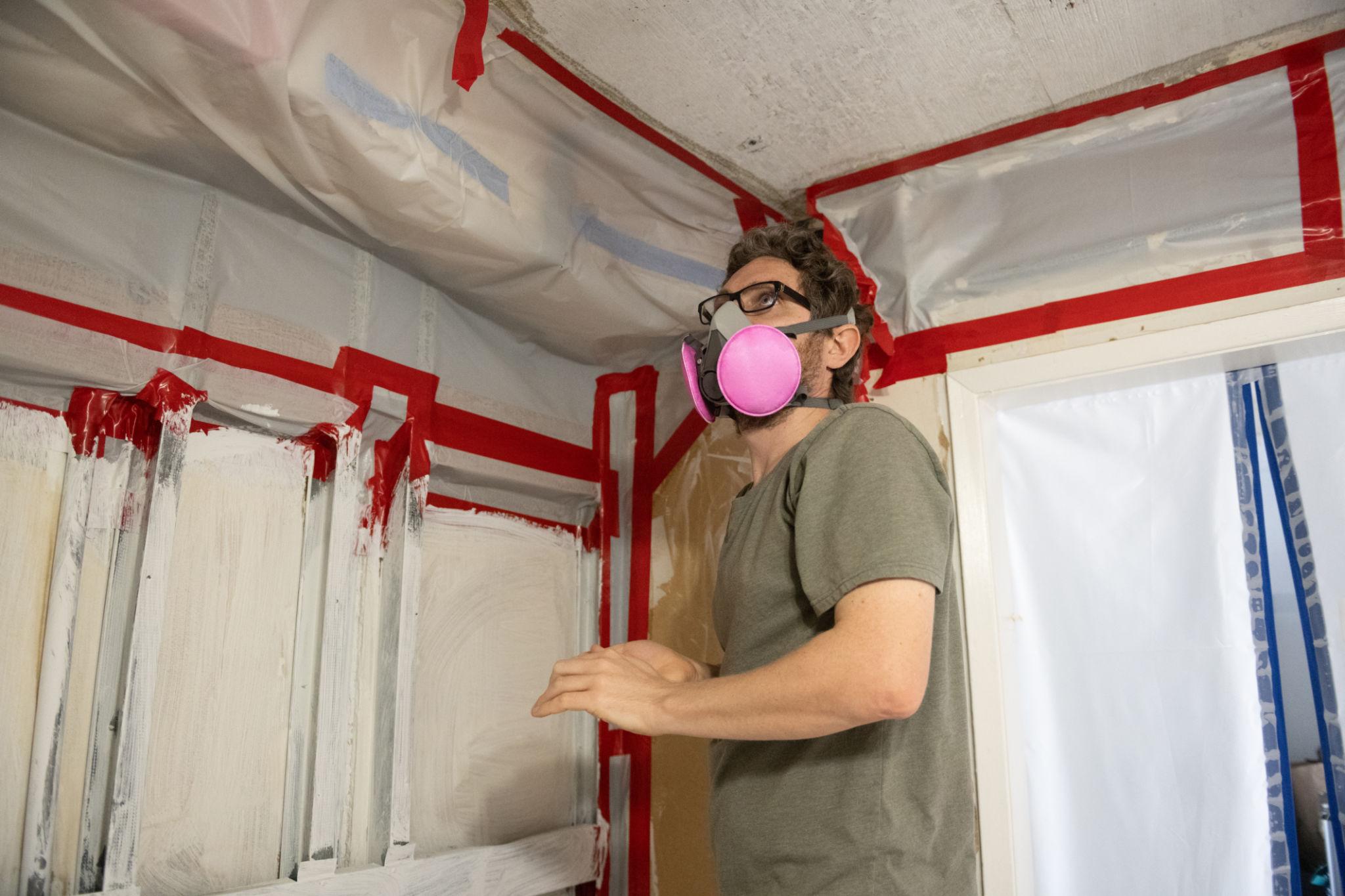Active mold remediation containment zone with HEPA scrubbers and industrial dehumidifiers running on schedule